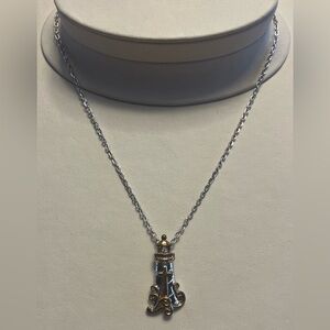 Silver and gold tone metal lighthouse cross pendant necklace